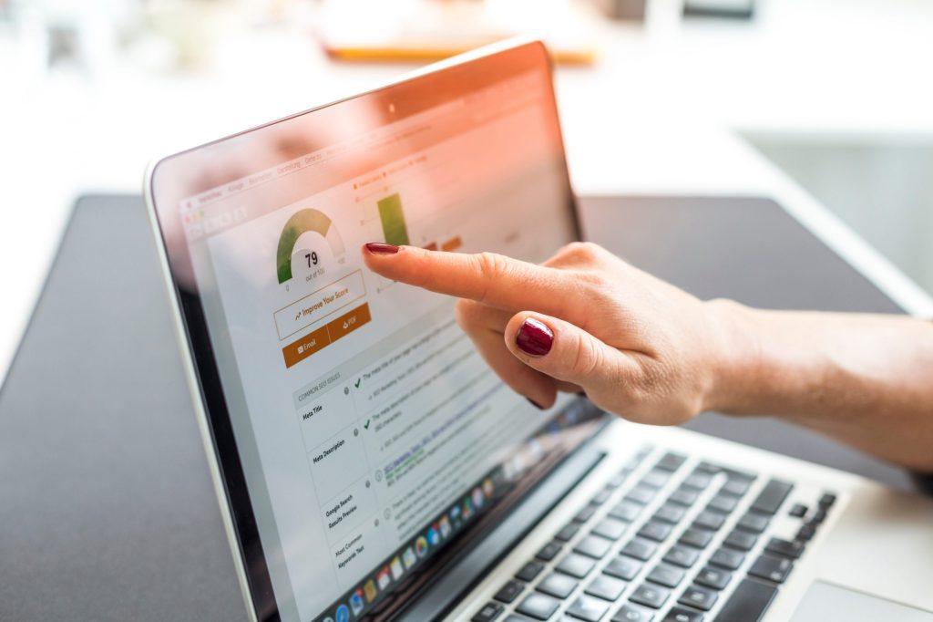 Hands pointing on a laptop, showing SEO and web development services.